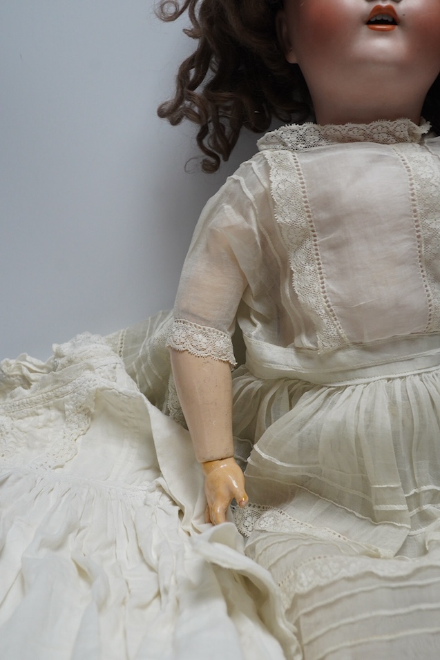 An Alt. Beck & Gottschalk bisque doll and three baby dresses, 61cm high. Condition - no visible hairline cracks to head or serious damage to body, dresses and dolls dress in good order, may need washing